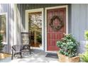 Charming front entrance with decorative wreath, stylish seating, and flagstone patio at 203 Old Forest Creek Dr, Chapel Hill, NC 27514