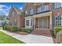 Inviting brick front porch with double doors and well-maintained landscaping at 208 Bridle Boast Rd, Cary, NC 27519