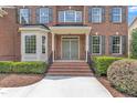 Charming front door entrance with brick steps and elegant black railing at 208 Bridle Boast Rd, Cary, NC 27519