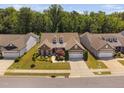 Aerial view of home, showcasing the surrounding neighborhood and mature trees at 211 Ibis Ln, Durham, NC 27703