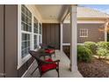 Side porch features seating and views of lush plantings at 211 Ibis Ln, Durham, NC 27703