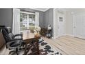 Well lit office space with large window, desk, stylish decor, and a view of the neighborhood at 220 Purslane Dr, Franklinton, NC 27525