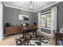 Stylish office with hardwood floors, gray walls, large window, desk and cowhide rug at 220 Purslane Dr, Franklinton, NC 27525