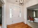 Bright foyer with hardwood floors features a white front door with sidelights and transom window at 2228 Walker Ave, Burlington, NC 27215