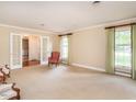 Spacious living room with neutral carpet, two windows, and French doors for a classic feel at 2228 Walker Ave, Burlington, NC 27215