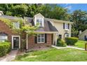 Charming townhome with brick and siding exterior, manicured lawn, and inviting entrance at 2233 Alpine Rd, Durham, NC 27707