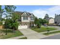 Lovely two-story home on a corner lot with a stone facade, attached garage, and well-maintained landscaping at 2361 Rainy Lake St, Wake Forest, NC 27587