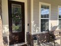 Close-up of the front door and porch featuring a decorative wreath and stylish exterior design at 2361 Rainy Lake St, Wake Forest, NC 27587