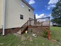 Backyard of a home, featuring a wooden deck with lattice and stairs at 2377 Vinson Rd, Clayton, NC 27527