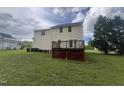 Backyard view of a two story house, including a deck, lawn, and landscaping at 2377 Vinson Rd, Clayton, NC 27527