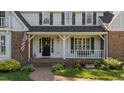 Inviting front porch with brick steps and charming decor at 2409 Beechview Ct, Raleigh, NC 27615