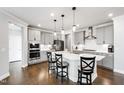 Modern kitchen featuring gray cabinets, a center island with bar stools, and stainless appliances at 272 High Woods Rdg, Chapel Hill, NC 27517