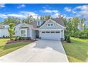 Inviting home featuring an attached two-car garage and a long concrete driveway at 30 Sawtooth Oak Ln, Youngsville, NC 27596