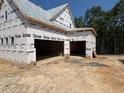 Unfinished three-car garage attached to a two story house at 332 Inspiration Way, Fuquay Varina, NC 27526