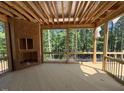 Unfinished sunroom with a fireplace and an outdoor view of the wooded back yard at 332 Inspiration Way, Fuquay Varina, NC 27526