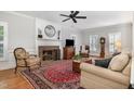 Cozy living room showcasing a fireplace, hardwood floors, and traditional furnishings at 4020 Gumleaf Dr, Apex, NC 27539