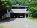 Two-story home featuring dual carports and a screened porch with a staircase entrance at 4144 Fairport Rd, Kittrell, NC 27544