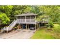 Beautifully elevated house with screened porch, convenient parking and lush greenery at 4144 Fairport Rd, Kittrell, NC 27544