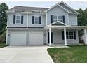 Charming two-story home with gray siding, blue shutters, and a two-car garage at 431 Mayview Dr, Creedmoor, NC 27522