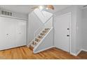 Bright entryway with hardwood floors, staircase, and ample closet space at 4705 Walden Pond Dr # 110-C, Raleigh, NC 27604