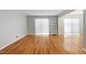 Sunlit living room with hardwood floors and large windows offering plenty of natural light at 4705 Walden Pond Dr # 110-C, Raleigh, NC 27604