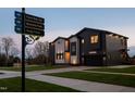 Modern, two-story home with a black and white facade, attached garage, and manicured lawn at 500 Grigsby Ave, Holly Springs, NC 27540