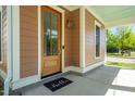 Inviting front entrance with a wooden door, a 'hello' mat, and well-maintained porch at 500 Spruce St, Durham, NC 27703