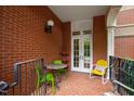 Cozy brick balcony with bright furniture, iron railings, and an inviting outdoor ambiance at 710 Independence Pl # 103, Raleigh, NC 27603