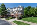 Townhome complex showcasing landscaped grounds, sidewalk, and covered front porches at 717 Samuel Cary Dr, Cary, NC 27511