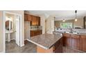 Spacious kitchen featuring an island, dark wood cabinetry, and stainless steel appliances at 717 Samuel Cary Dr, Cary, NC 27511
