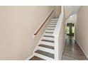 Light and airy staircase with wood handrail and hardwood flooring at 717 Samuel Cary Dr, Cary, NC 27511