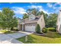 Attractive home featuring a brick facade, a two-car garage, and a well-manicured lawn at 736 Varina Ln, Fuquay Varina, NC 27526