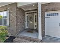 Welcoming front entrance featuring a brick facade, decorative wreath, and a 'HELLO' doormat at 736 Varina Ln, Fuquay Varina, NC 27526