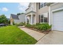 Close up of charming two-story home with lush landscaping and a well-maintained walkway leading to the entrance at 7612 Vista Del Rey Ln, Raleigh, NC 27613