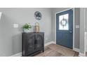 Stylish foyer featuring a modern black cabinet, lovely decor, and a welcoming front door at 784 Cypress Rd, Cameron, NC 28326
