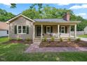 Charming home with covered front porch, green shutters, and manicured landscaping at 847 E Maple Ln, Fuquay Varina, NC 27526