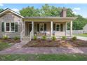 Charming one-story home featuring a welcoming front porch, neutral siding, and lush landscaping, set on a beautiful lot at 847 E Maple Ln, Fuquay Varina, NC 27526