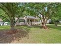 Charming one-story home featuring a welcoming front porch, neutral siding, and lush landscaping, set on a beautiful lot at 847 E Maple Ln, Fuquay Varina, NC 27526