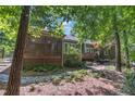 Backyard featuring a spacious screened porch, patio area, and lush landscaping, perfect for outdoor living at 850 N Langdon, Pittsboro, NC 27312