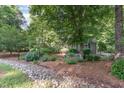 Beautifully landscaped front yard featuring lush garden beds and mature trees, enhancing curb appeal at 850 N Langdon, Pittsboro, NC 27312