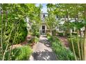 Charming home with a walkway lined with lush greenery leading to the front door at 1003 Crimson Dr, Durham, NC 27713