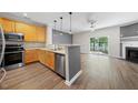 Modern kitchen with stainless steel appliances and seamless flow to the living area at 1003 Crimson Dr, Durham, NC 27713