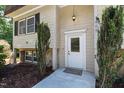 Close up of the front entrance featuring a welcoming door and well-maintained landscaping at 1005 Temple St, Raleigh, NC 27609