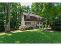 Traditional two-story home surrounded by lush greenery, offering a serene and private setting at 1005 Temple St, Raleigh, NC 27609