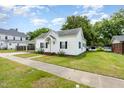 Quaint one-story home with a covered carport and a well-maintained lawn at 102 S College Ave, Kenly, NC 27542