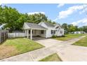 Spacious lot featuring a covered carport, driveway and a well-manicured yard at 102 S College Ave, Kenly, NC 27542