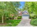Charming two-story home with brick and siding, red shutters, and a well-maintained lawn at 102 Winged Foot Ct, Mebane, NC 27302