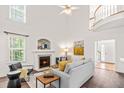 Bright living room boasts a fireplace, vaulted ceilings, and an upper-level balcony at 1033 Cabin Hill Way, Garner, NC 27529