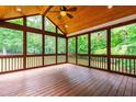 Screened-in porch with wood floors and ceiling provides a great view of the trees at 1033 Cabin Hill Way, Garner, NC 27529