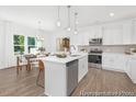 Open kitchen with island, stainless steel appliances, and adjacent dining area at 105 Mable Court # 10, Lillington, NC 27546